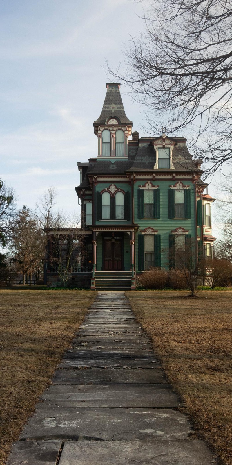 A Victorian house among bare winter trees